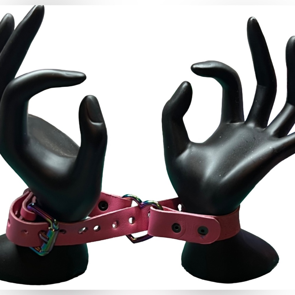 Hot pink discreet restraint bracelet with gunmetal heart, rivets and buckle.